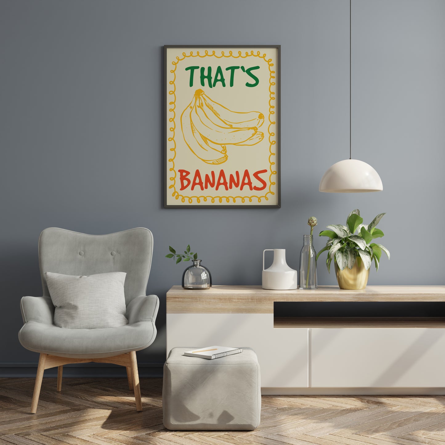 Graphic banana wall art in playful retro style featuring mustard yellow banana drawing, green and red “THAT’S BANANAS” text and decorative yellow frame on cream.