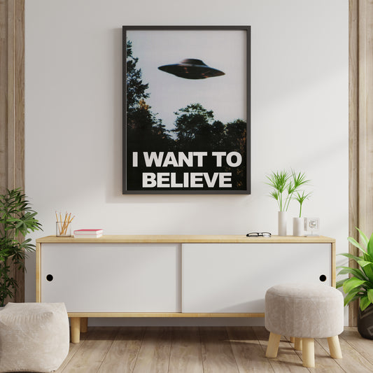 UFO poster with the words I Want to Believe displayed on a bright living room wall.