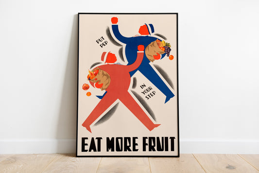 Eat More Fruit typography poster with red and blue fruit illustration leaning against a white wall.