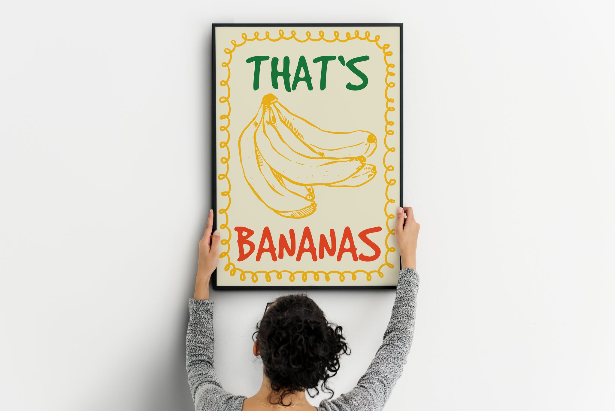 Vintage inspired food illustration wall art featuring yellow banana cluster, green “THAT’S” and red “BANANAS” typography and looping yellow border on cream background.