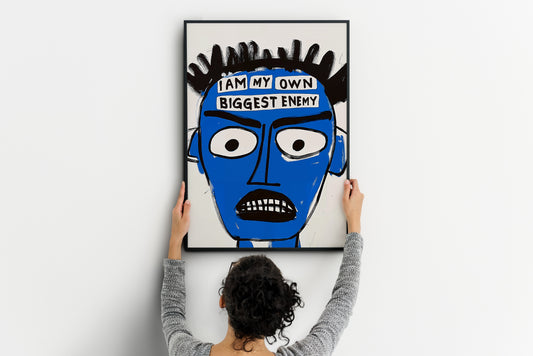 large Basquiat-style blue face poster being placed on wall, abstract portrait print