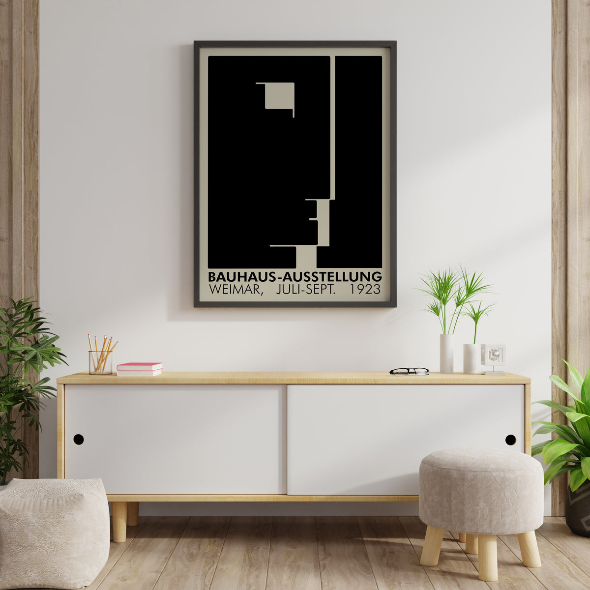 Bauhaus-Ausstellung Weimar 1923 poster displayed in a modern room above a white console table with plants and books