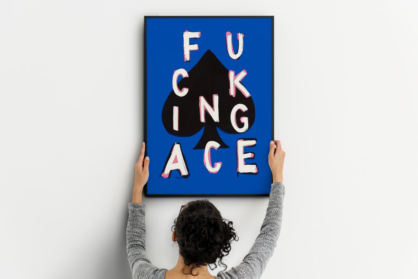 Bold ace poker print being placed on a clean wall