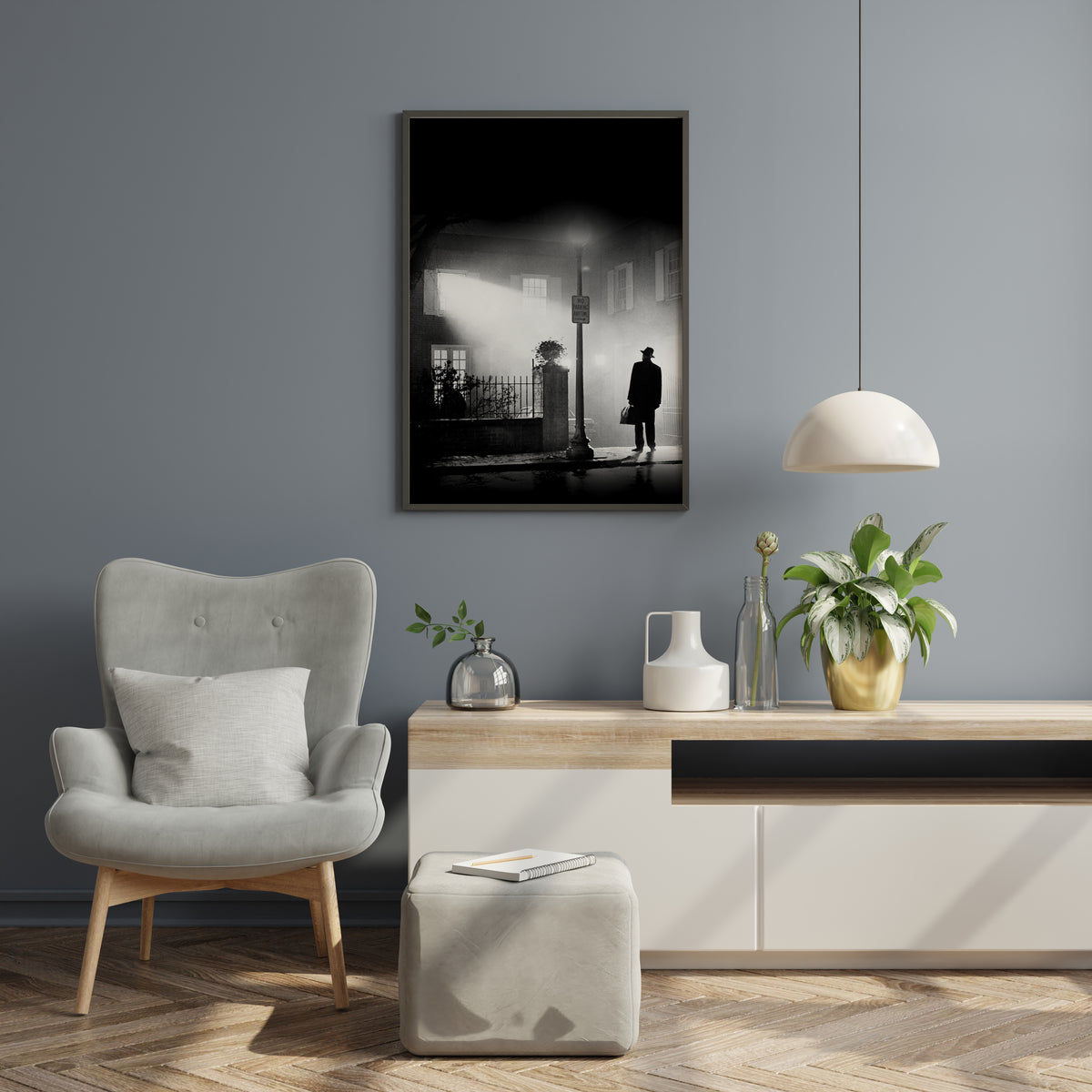 Exorcist movie poster black and white street scene with solitary figure in hat and coat standing on wet street at night illuminated by streetlamp casting beam through fog with building and windows in misty background
