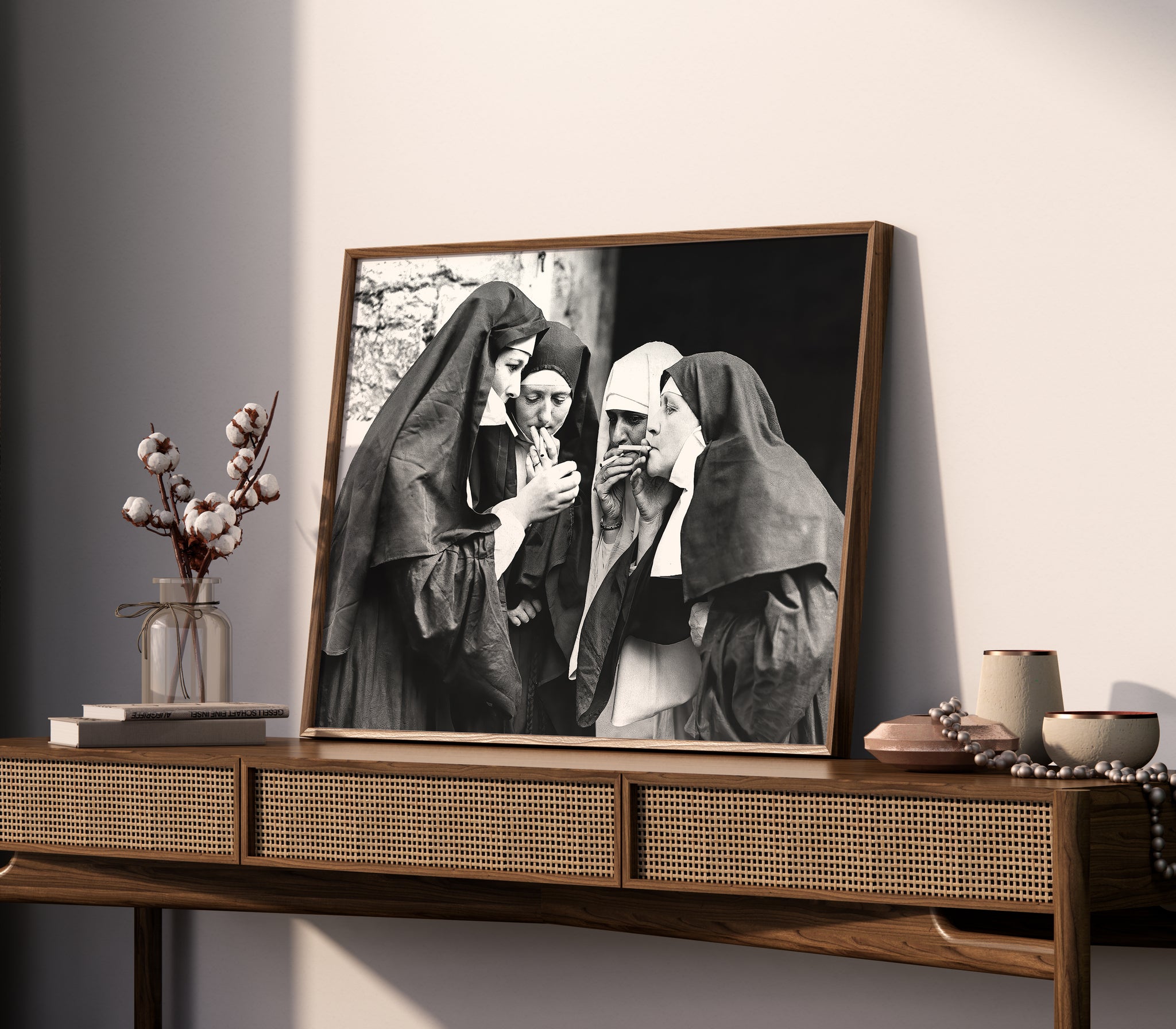 Close lifestyle view of a black-and-white photo print showing four nuns smoking cigarettes.