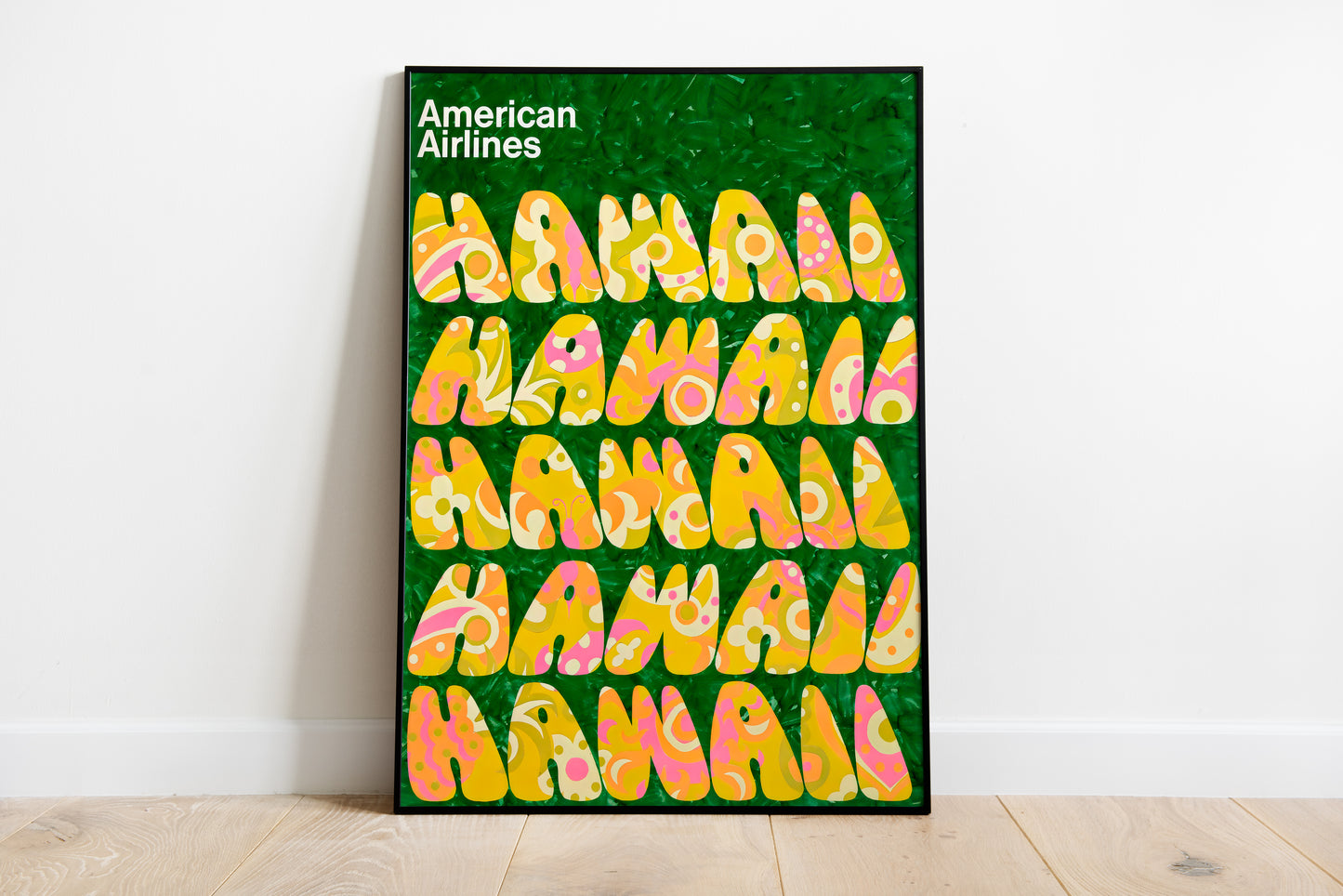 Large Hawaii poster held against a plain living room wall