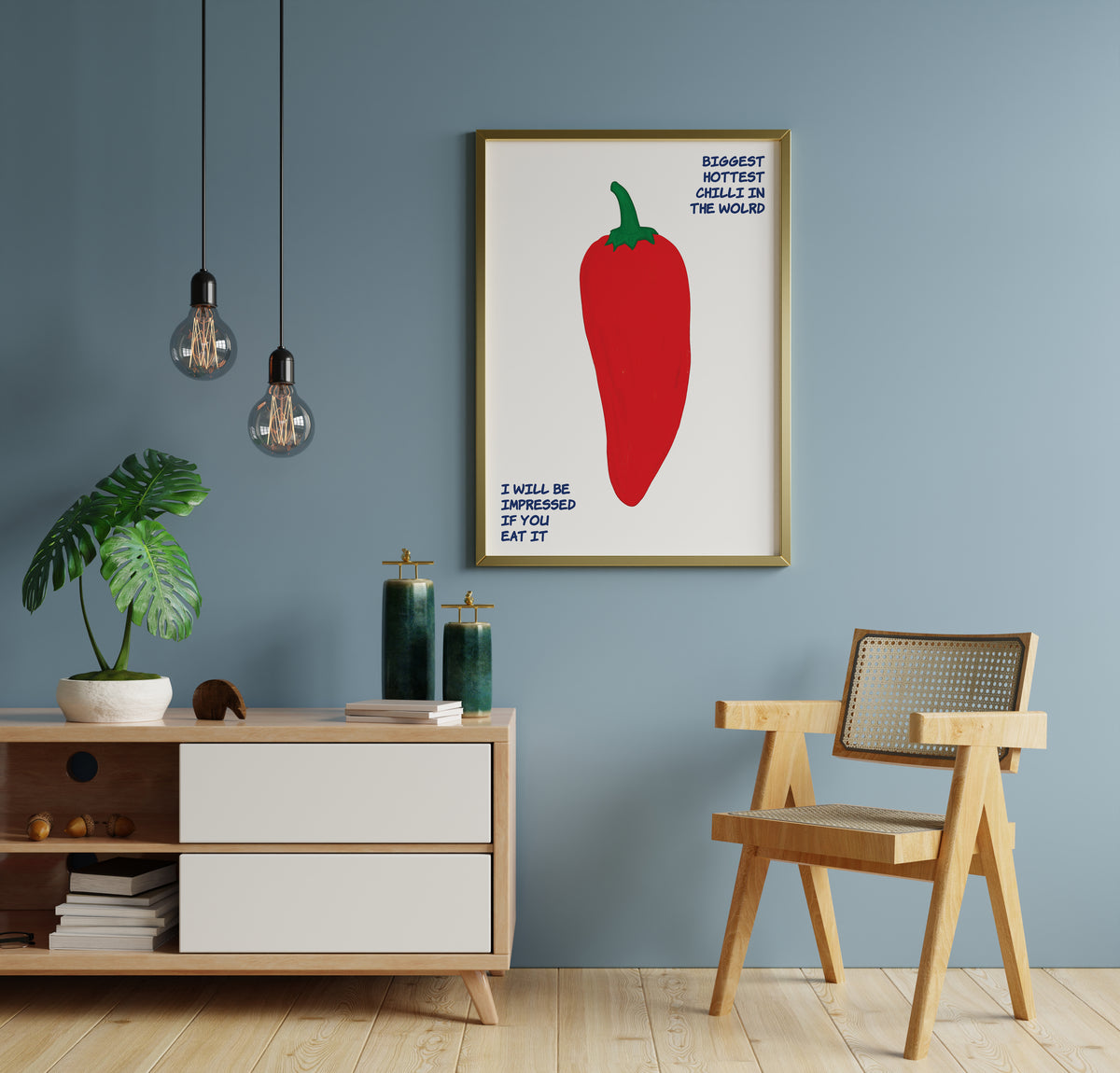 Hottest chilli wall art with a large red pepper and humorous lettering in a styled room