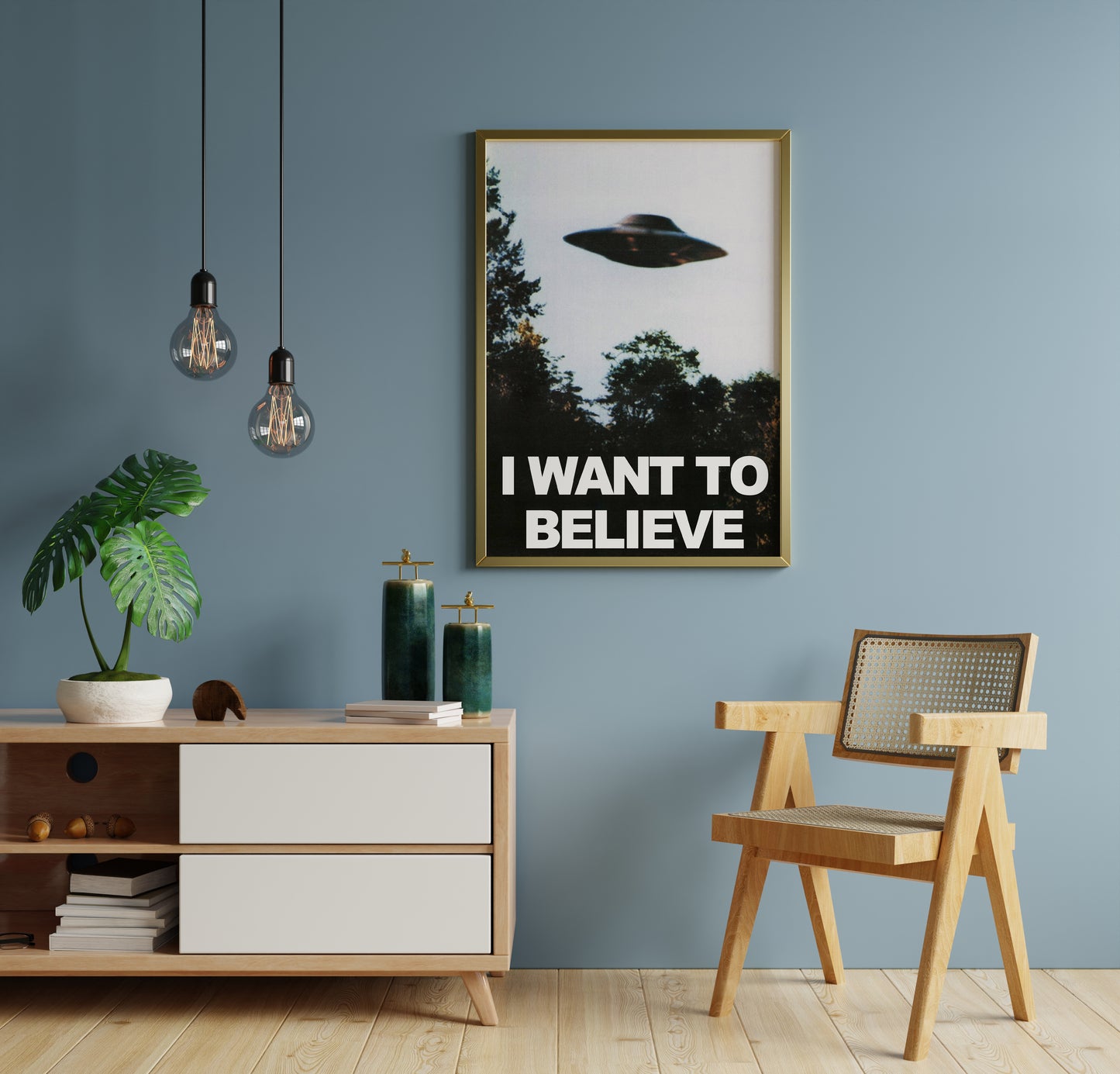 Flying saucer wall art with dark trees and bold text displayed against a blue interior wall.