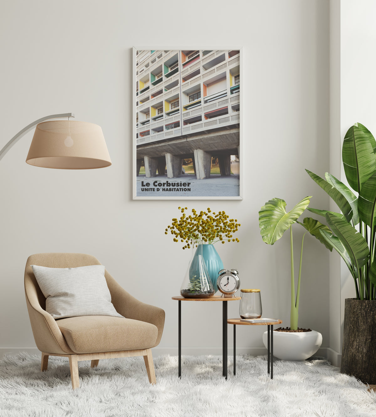 Le Corbusier Unite D'Habitation poster displayed in a modern living room with beige furniture and plants.