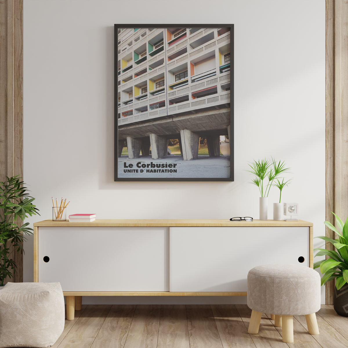 Le Corbusier Unite D'Habitation poster on a white wall above a wooden sideboard in a modern living room