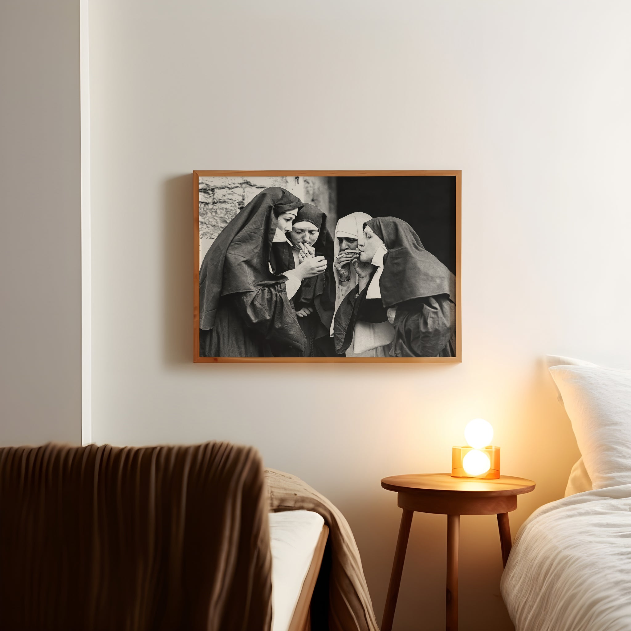 Monochrome smoking nuns poster showing four figures with cigarettes on a bedroom wall.