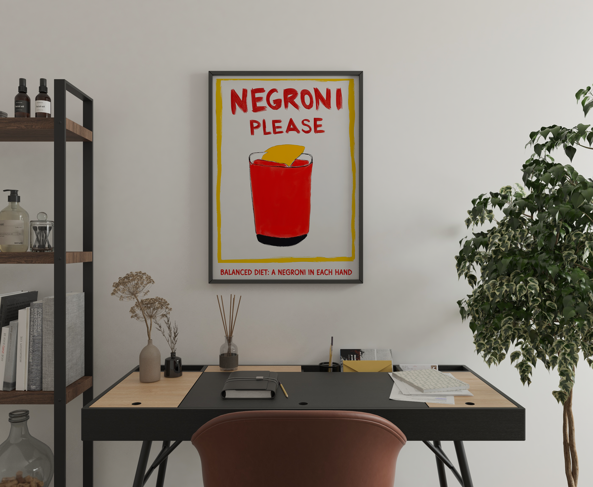 Negroni quote poster with cocktail illustration displayed above a home office desk