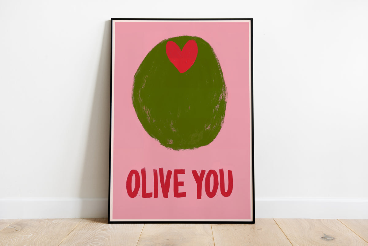 Olive poster with large green olive, red heart and bold OLIVE YOU text on a pink background