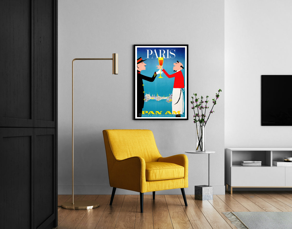 Paris Pan Am poster with bold serif PARIS text and red, yellow and blue artwork in a living room.