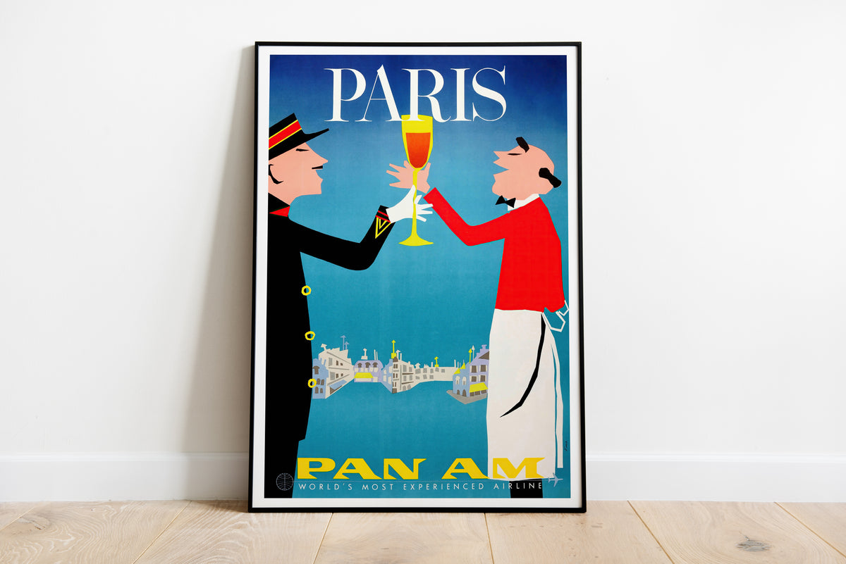 Pan Am Paris poster with two stylized figures raising a glass, cityscape and bold PARIS lettering.