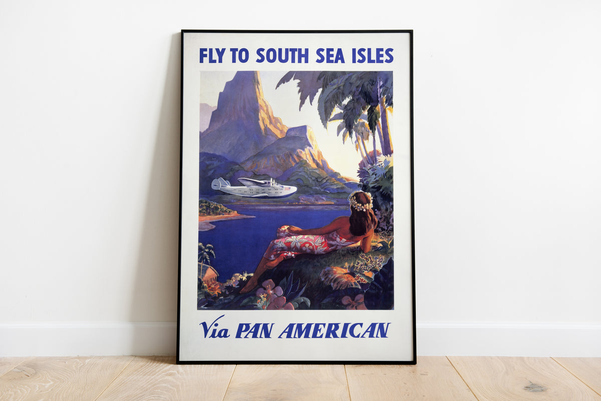Pan American South Sea Isles poster with flying boat, lagoon, mountain and reclining woman.