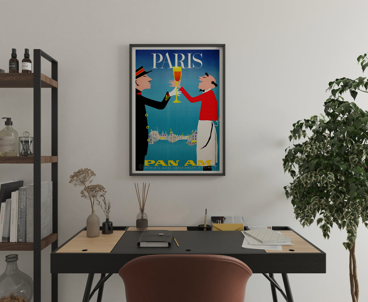 Pan Am Paris travel art with illustrated figures and cityscape displayed in a home office.