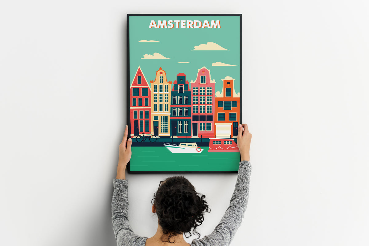 person holding colorful Amsterdam canal houses travel poster