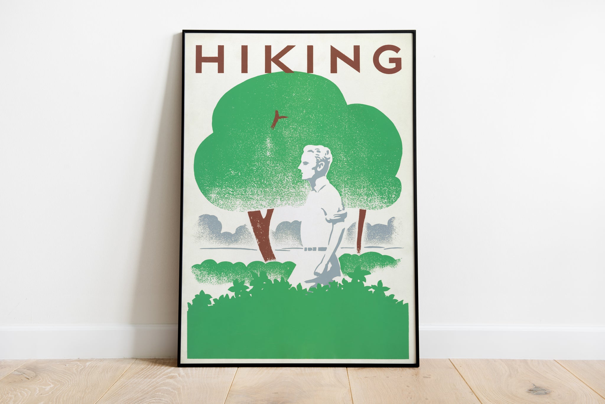 Retro hiking poster with a lone walker beneath oversized green trees and bold HIKING typography.