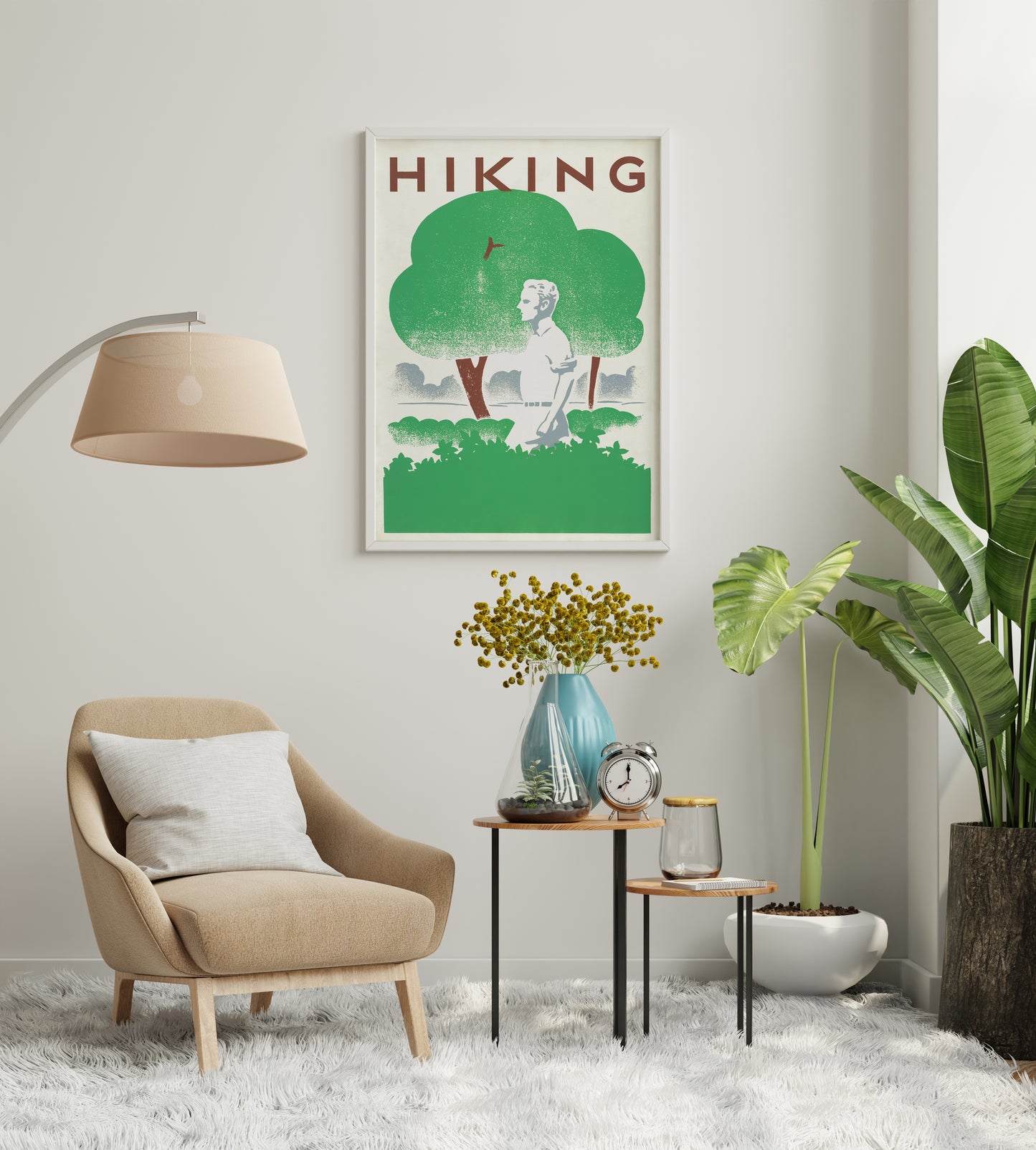 Large retro hiking print being positioned on a wall, showing a lone walker beneath green trees.
