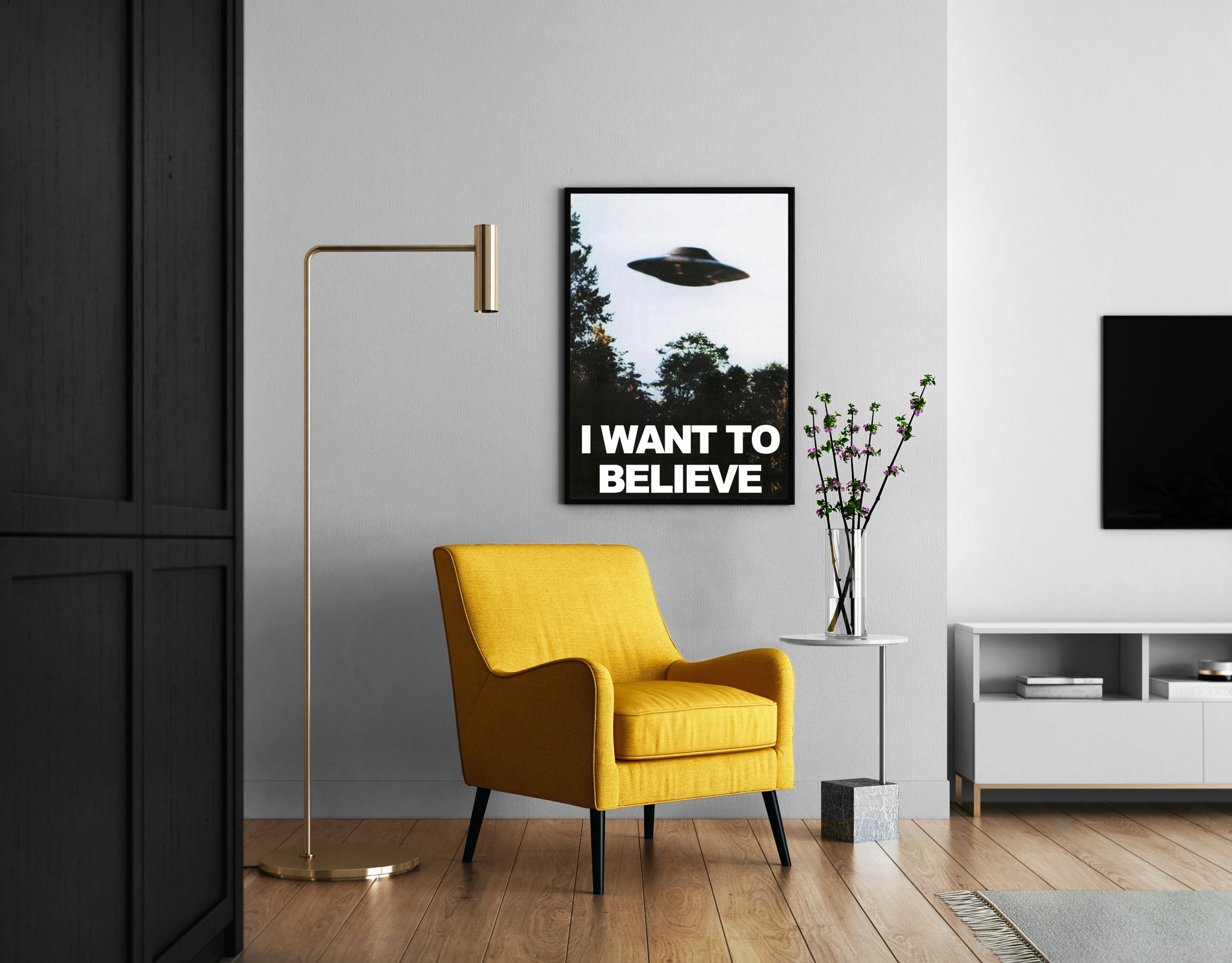 Retro flying saucer print with bold white typography shown in a modern reading corner.