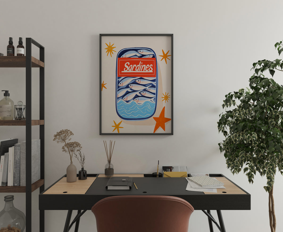 Sardine tin poster with fish illustration and retro label displayed above a home office desk